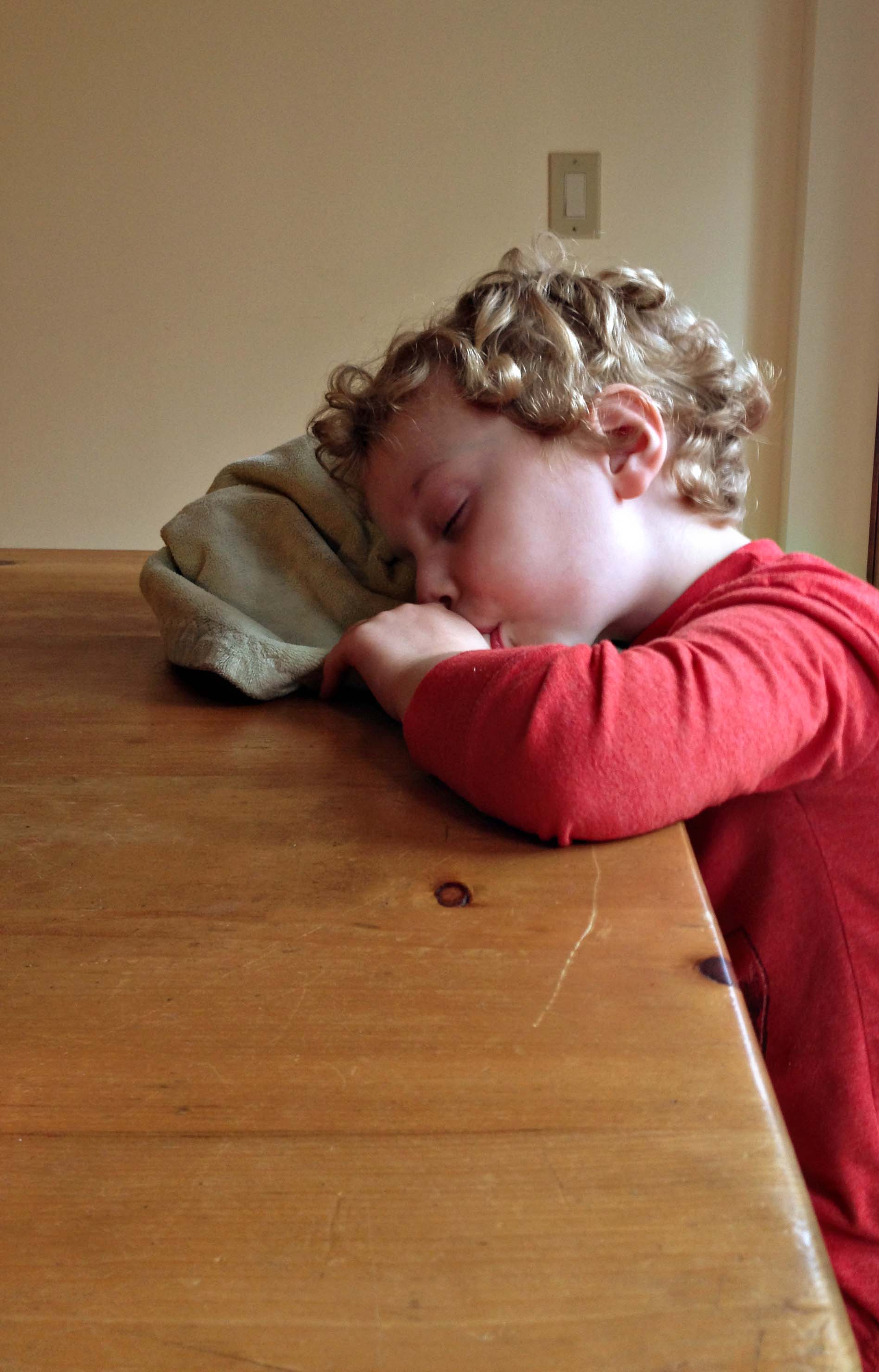 Asleep at the table.