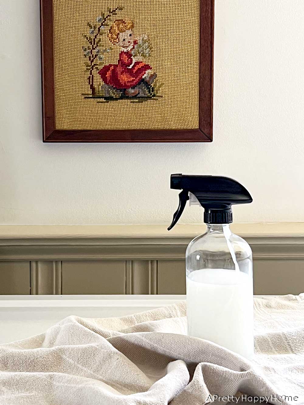the perk of decanting laundry detergent in a modern country laundry room with inset shelves and wainscoting