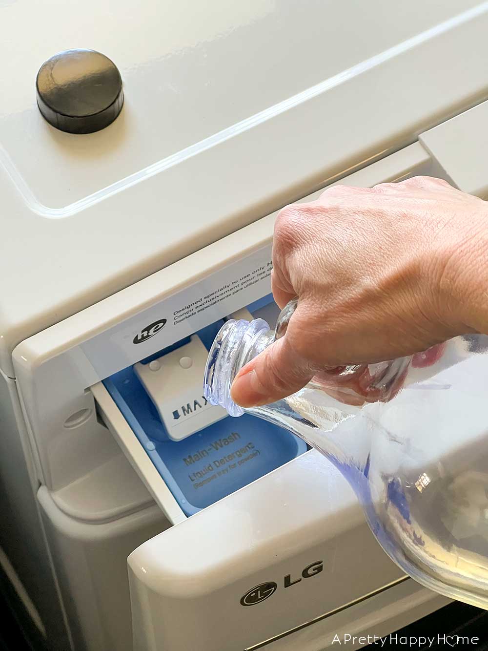 the perk of decanting laundry detergent in a modern country laundry room with inset shelves and wainscoting