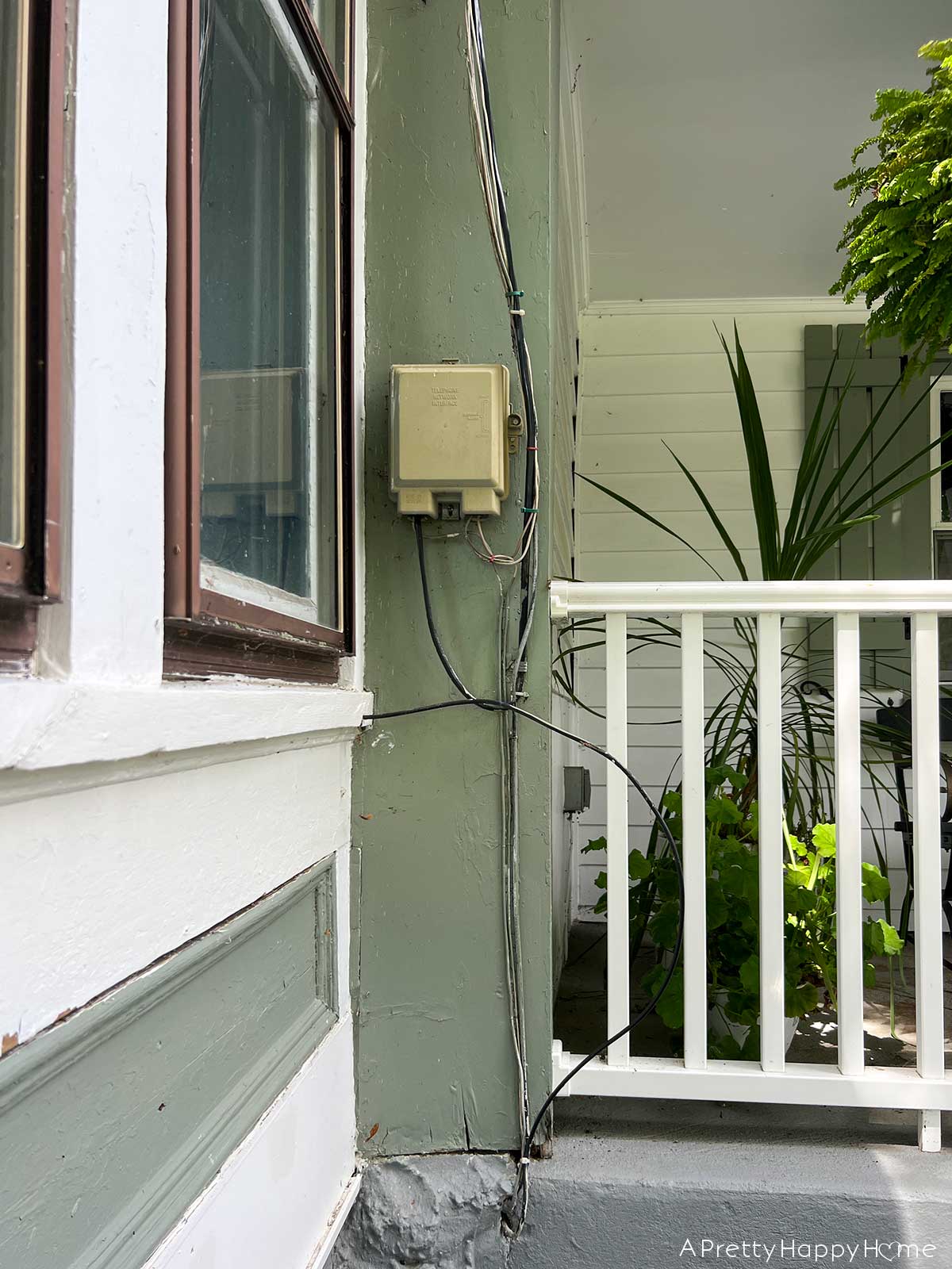 Caulk, Cracks, and Home Maintenance. Wood siding maintenance, scraping chipping paint, sanding, removing old telephone box repainting on an old house 