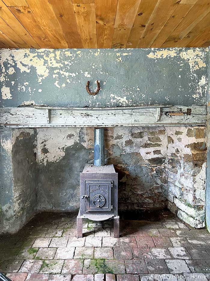 an epic stone fireplace makeover BEFORE photo of stone fireplace that needed repointing with lime mortar