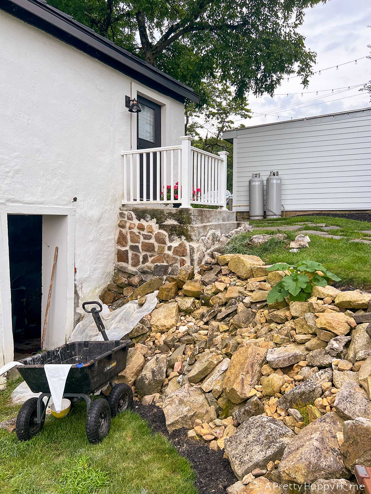 fieldstone porch made with fieldstone and lime mortar skimmed over concrete on a 250-year-old carriage house