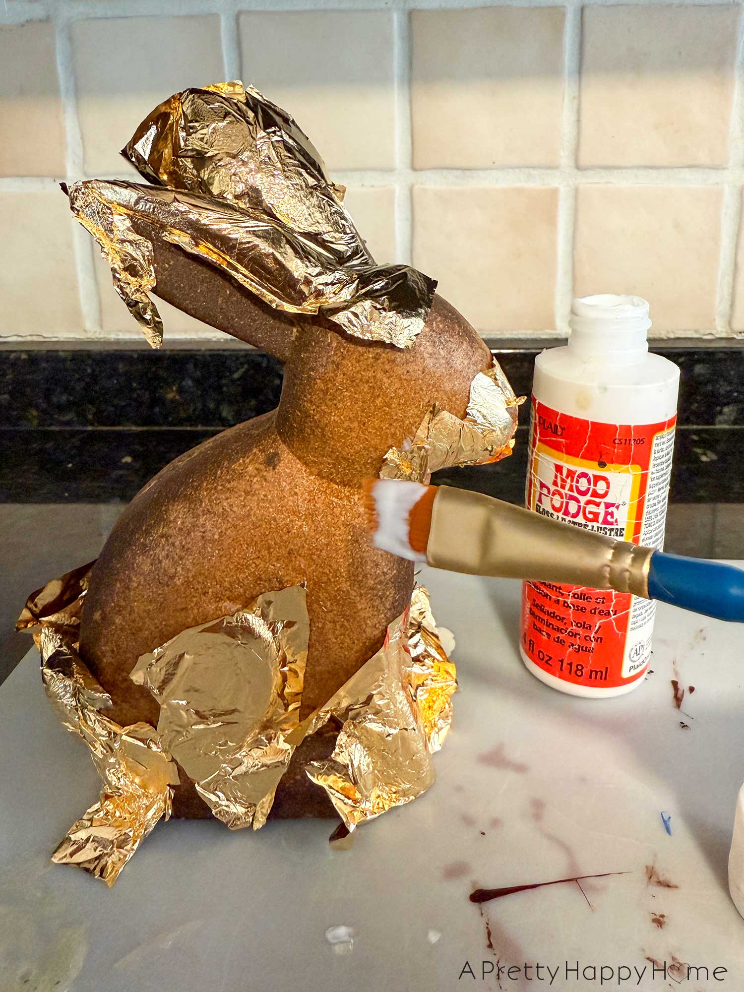 faux chocolate easter bunny made with wood bunny and gold leaf