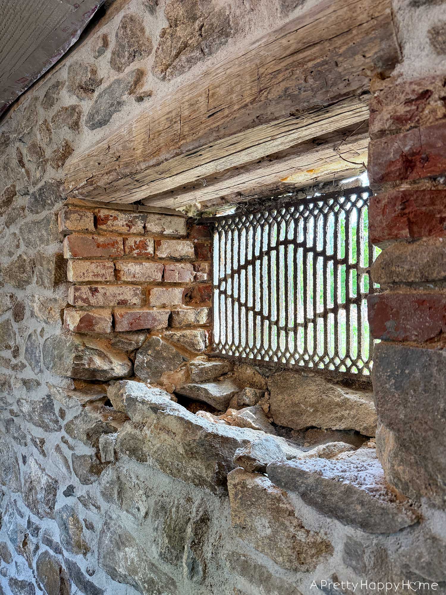 antique window grate in a stone wall