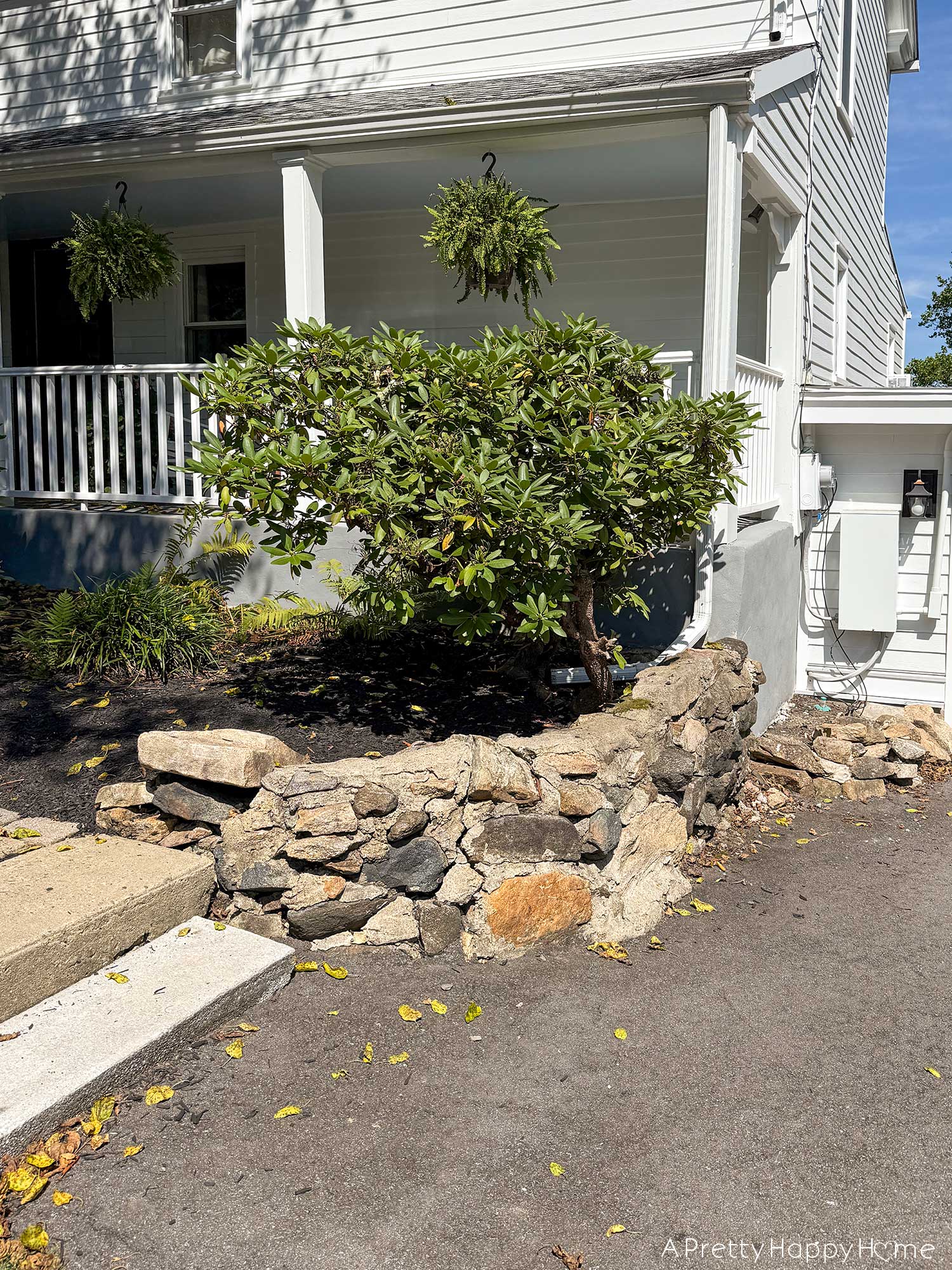 BEFORE photo of crumbling fieldstone wall