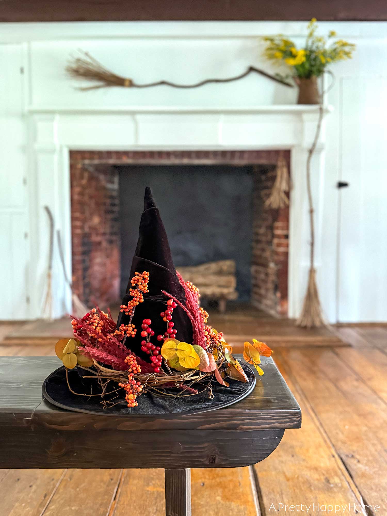 Witchy Halloween Mantel - No Cost Decorating Ideas fireplace decorated with witch's brooms for halloween