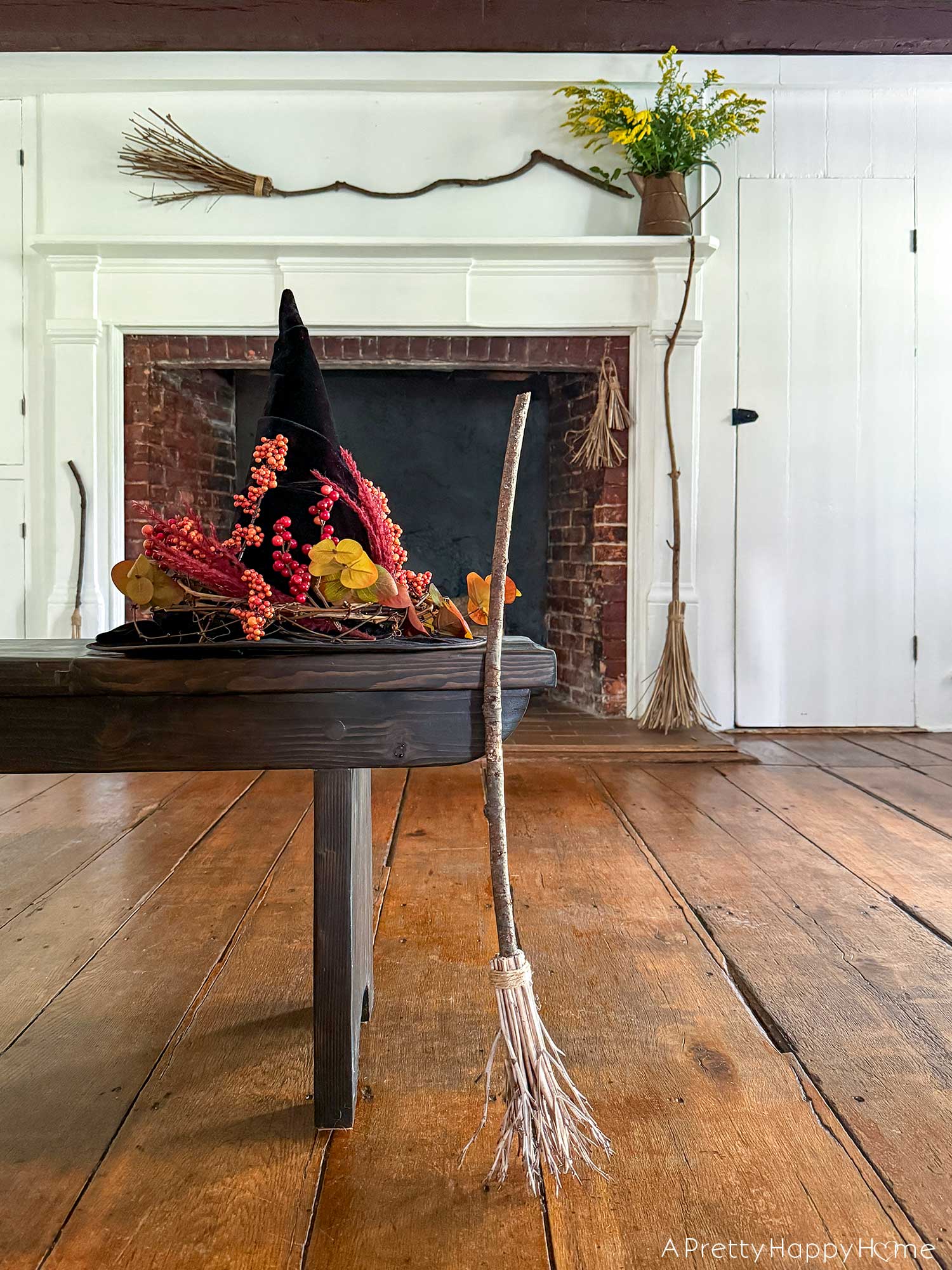 Witchy Halloween Mantel - No Cost Decorating Ideas fireplace decorated with witch's brooms for halloween