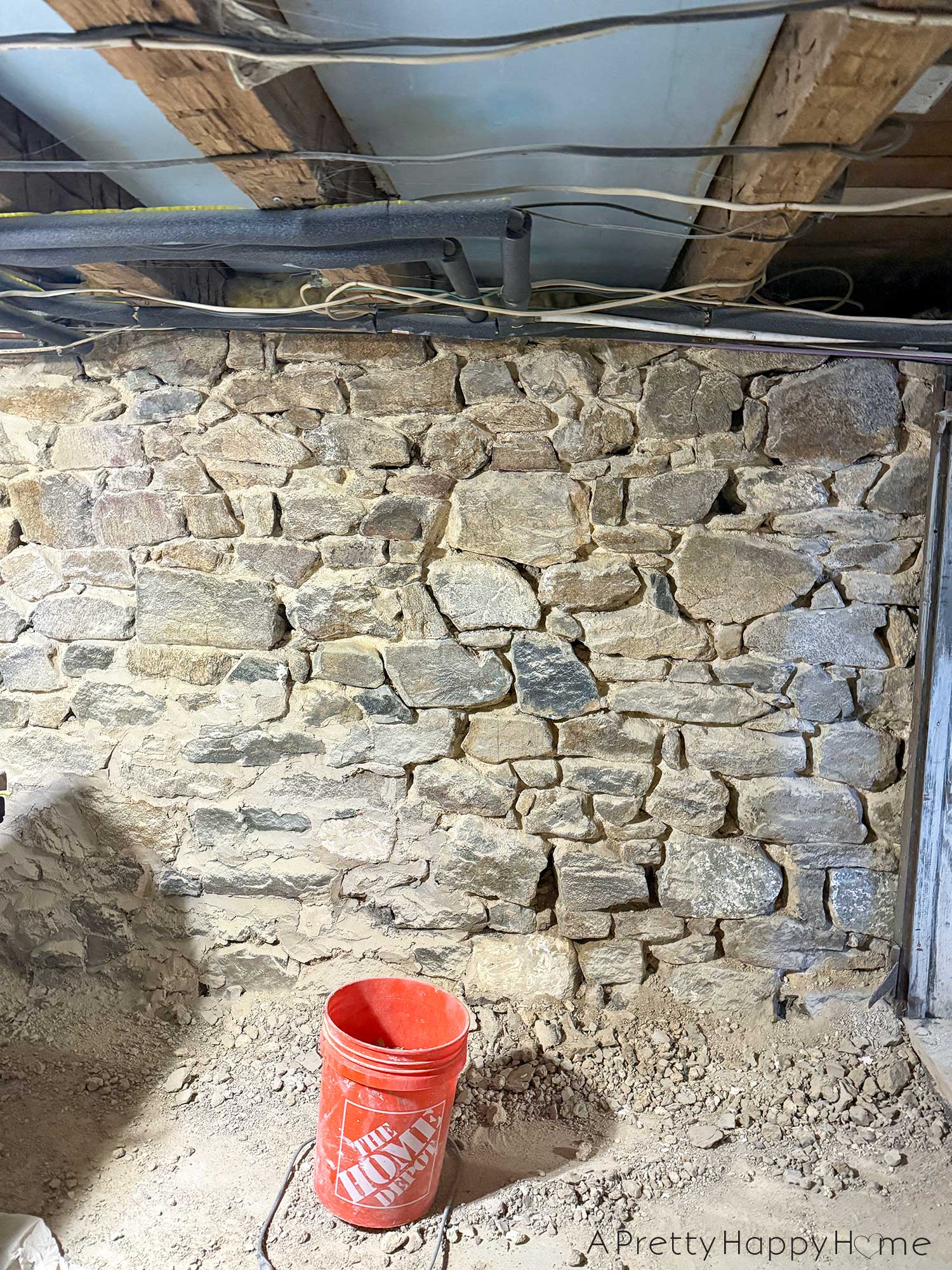 stone foundation from the 1780s being chipped out in order to be repointed with lime mortar made from natural hydraulic lime
